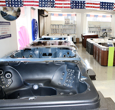 Rows of above-ground pool wall panels and frame samples on the showroom floor