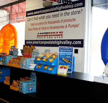 Tropic Seas spa on a raised platform with LED lights glowing in the showroom