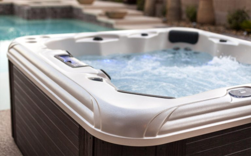 Tropic Seas spa in a family backyard setting at twilight